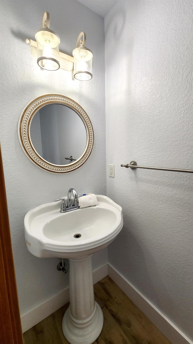 bathroom featuring baseboards and wood finished floors