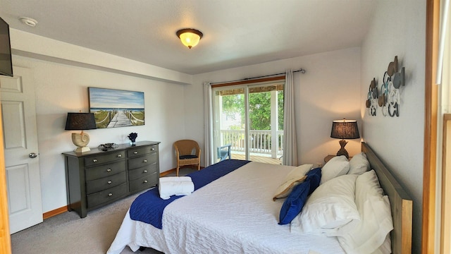 bedroom with access to exterior and light colored carpet