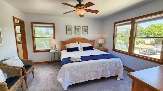 bedroom featuring ceiling fan, carpet flooring, and baseboards