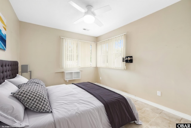1115 Waterlily Rd, Coinjock, NC 27923 - bedroom with ceiling fan and light tile patterned floors