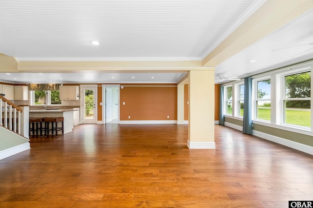 1115 Waterlily Rd, Coinjock, NC 27923 - unfurnished living room with ornamental molding, healthy amount of natural light, light wood finished floors, recessed lighting, and stairs