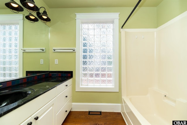 1115 Waterlily Rd, Coinjock, NC 27923 - full bath with vanity, plenty of natural light, and wood finished floors