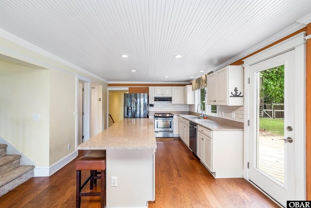 1115 Waterlily Rd, Coinjock, NC 27923 - kitchen with stainless steel appliances, a center island, recessed lighting, crown molding, and wood finished floors