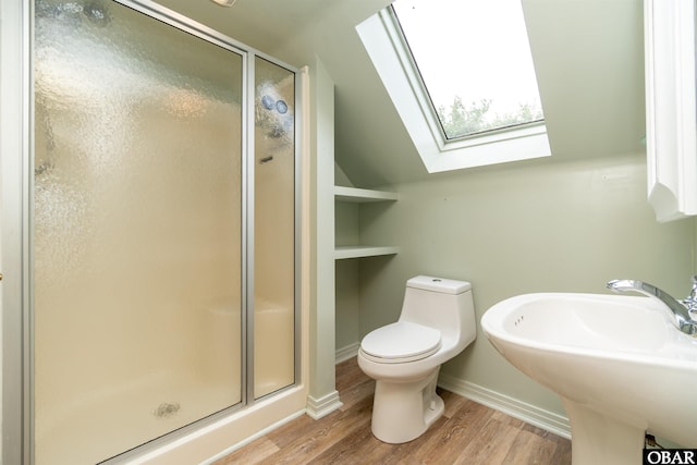 1115 Waterlily Rd, Coinjock, NC 27923 - bathroom with a skylight, a shower stall, wood finished floors, and lofted ceiling