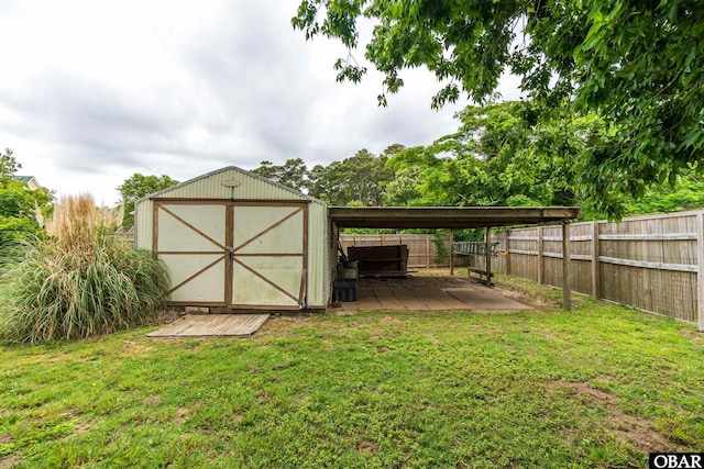 1115 Waterlily Rd, Coinjock, NC 27923 - view of shed featuring a fenced backyard and a carport