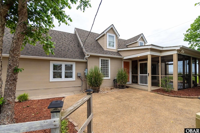 1115 Waterlily Rd, Coinjock, NC 27923 - view of front of house featuring a sunroom and roof with shingles