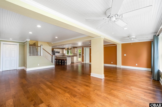 1115 Waterlily Rd, Coinjock, NC 27923 - unfurnished living room with ceiling fan, recessed lighting, crown molding, stairs, and wood finished floors