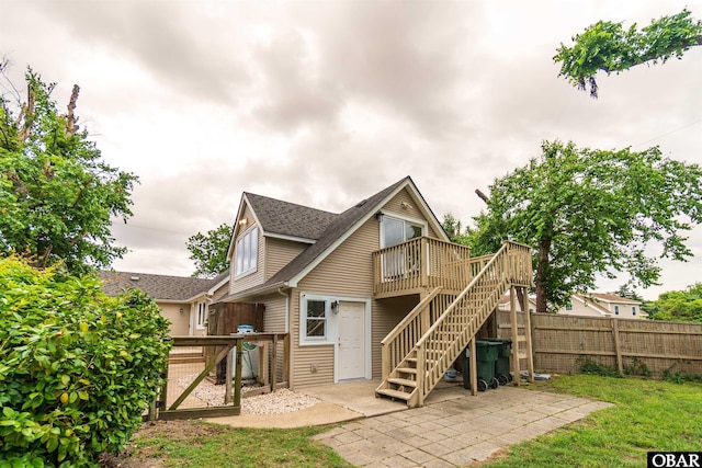 1115 Waterlily Rd, Coinjock, NC 27923 - back of property featuring a wooden deck, stairway, a shingled roof, a patio, and a gate