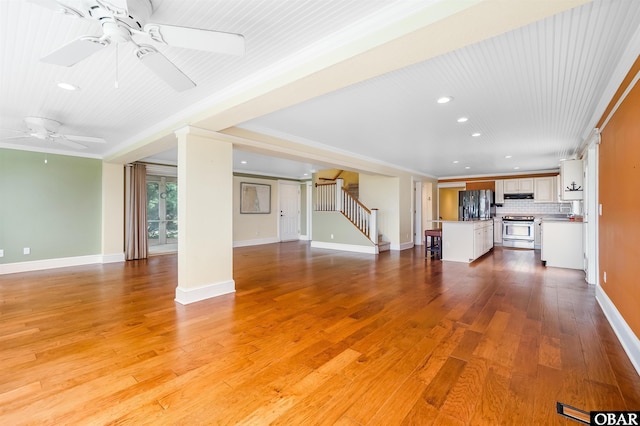 1115 Waterlily Rd, Coinjock, NC 27923 - unfurnished living room with ceiling fan, stairway, recessed lighting, and light wood-style floors