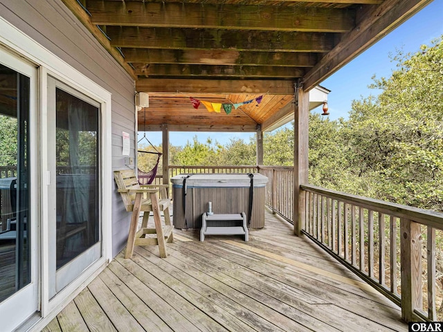 wooden terrace with a hot tub