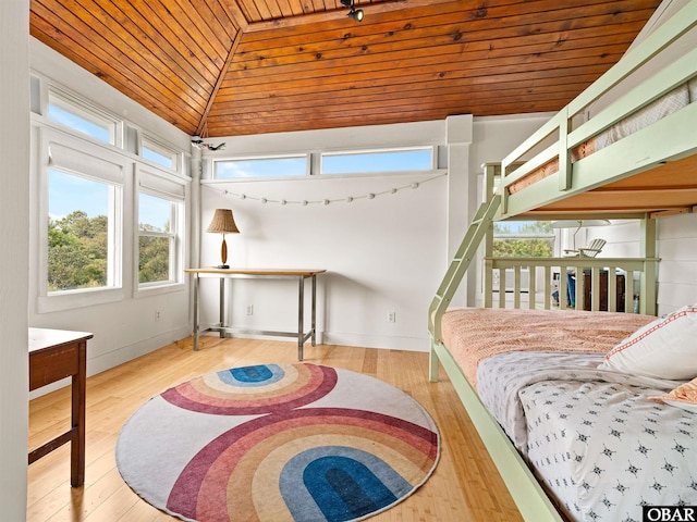 bedroom featuring wood finished floors, vaulted ceiling, and wood ceiling