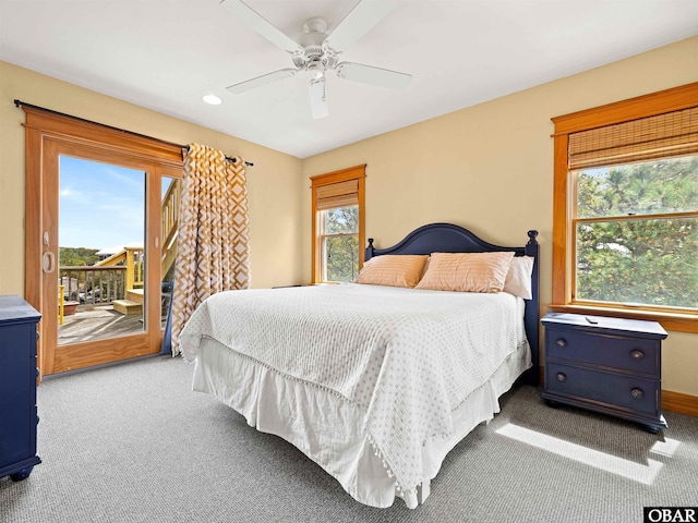 bedroom featuring multiple windows, access to exterior, and carpet