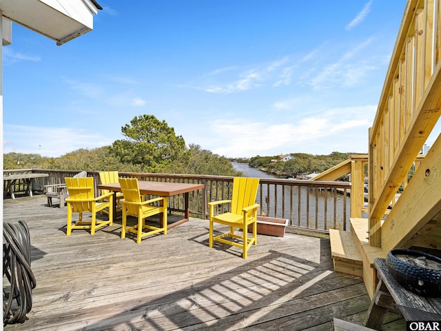 wooden terrace featuring a water view