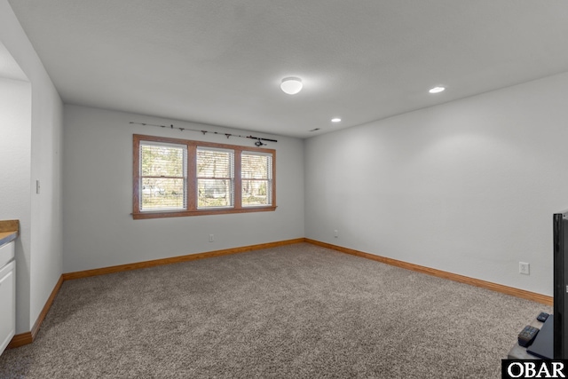 carpeted empty room with recessed lighting and baseboards