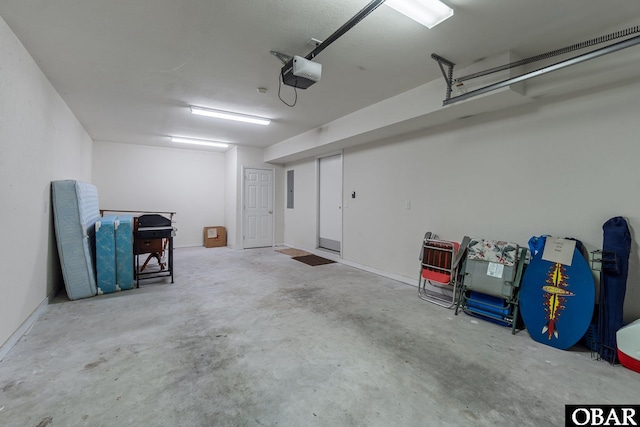 garage featuring a garage door opener and electric panel