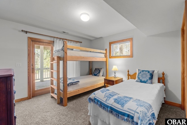 bedroom featuring access to exterior, carpet, multiple windows, and baseboards