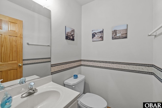 bathroom with toilet and vanity