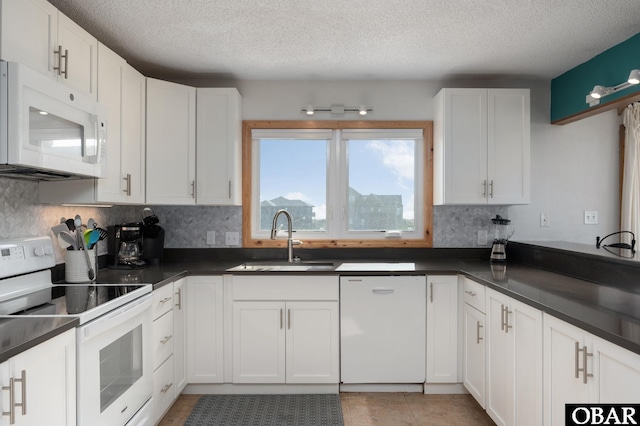 42082 Ocean View Dr Lot 67, Avon, NC 27915 - kitchen with white appliances, a sink, dark countertops, decorative backsplash, and a textured ceiling