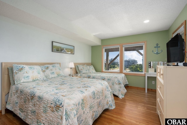 42082 Ocean View Dr Lot 67, Avon, NC 27915 - bedroom featuring wood finished floors, a textured ceiling, baseboards, and recessed lighting