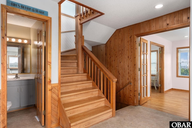 42082 Ocean View Dr Lot 67, Avon, NC 27915 - stairway featuring wood walls, tile patterned flooring, a textured ceiling, and lofted ceiling
