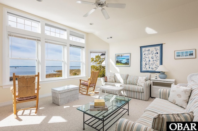 living area with visible vents, baseboards, ceiling fan, lofted ceiling, and carpet floors