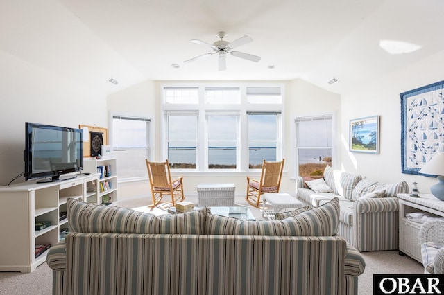 living area with lofted ceiling, ceiling fan, visible vents, and light colored carpet