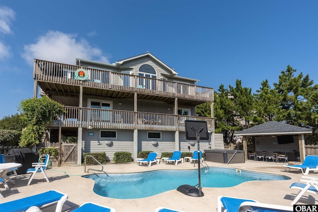 1024 Lighthouse Dr Lot 14, Corolla, NC 27927 - back of house with a jacuzzi, a patio, and a community pool