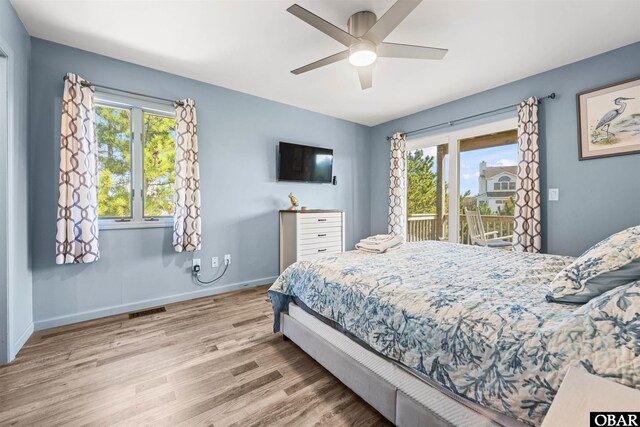 1024 Lighthouse Dr Lot 14, Corolla, NC 27927 - bedroom featuring access to outside, wood finished floors, multiple windows, and a ceiling fan