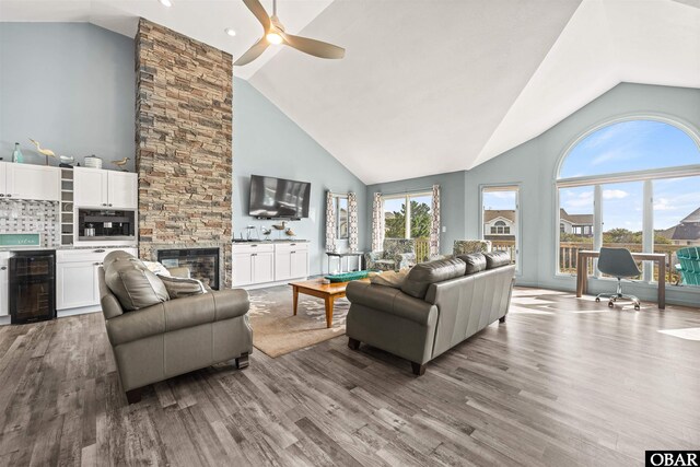 1024 Lighthouse Dr Lot 14, Corolla, NC 27927 - living area featuring beverage cooler, a ceiling fan, wood finished floors, high vaulted ceiling, and a fireplace