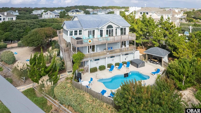 1024 Lighthouse Dr Lot 14, Corolla, NC 27927 - back of house featuring a fenced backyard, a balcony, stairs, and a patio area