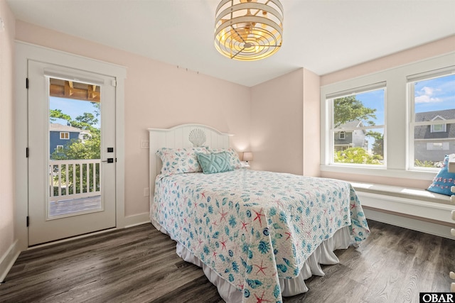 bedroom featuring multiple windows, baseboards, and dark wood finished floors