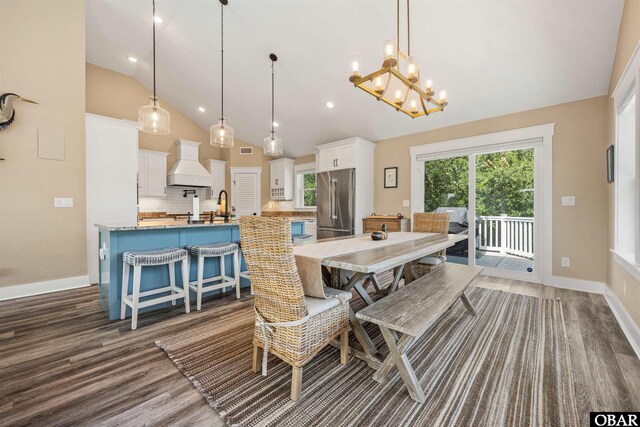 dining room with high vaulted ceiling, dark wood finished floors, visible vents, and baseboards