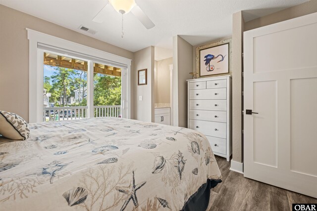 bedroom featuring dark wood-style floors, a ceiling fan, visible vents, and access to exterior