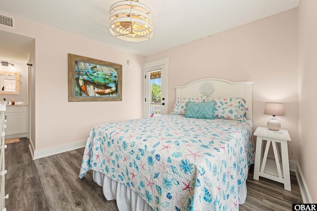 bedroom with dark wood-style floors, visible vents, and baseboards