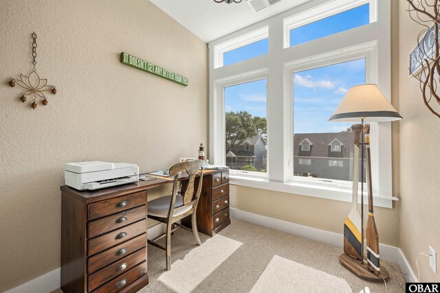 home office with light carpet and baseboards