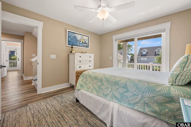 bedroom featuring dark wood-style floors, ceiling fan, and baseboards