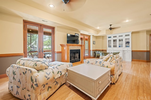 living room featuring light wood-type flooring, french doors, ceiling fan, and recessed lighting