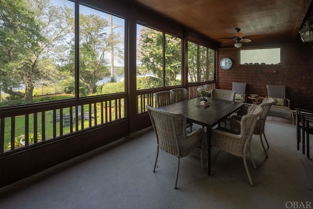 sunroom with a healthy amount of sunlight and ceiling fan