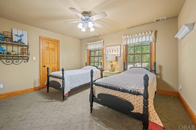 bedroom with ceiling fan, carpet flooring, visible vents, and baseboards