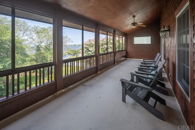 sunroom featuring plenty of natural light, vaulted ceiling, and a ceiling fan