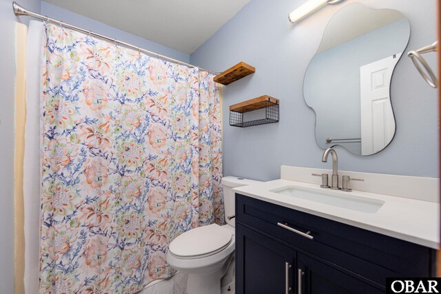 full bathroom with toilet, curtained shower, and vanity