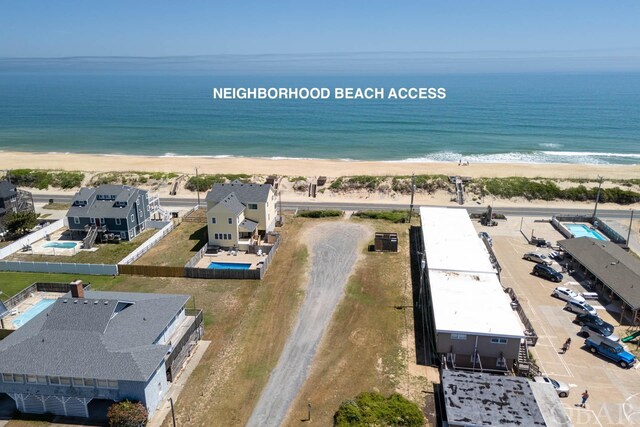 birds eye view of property with a water view and a view of the beach