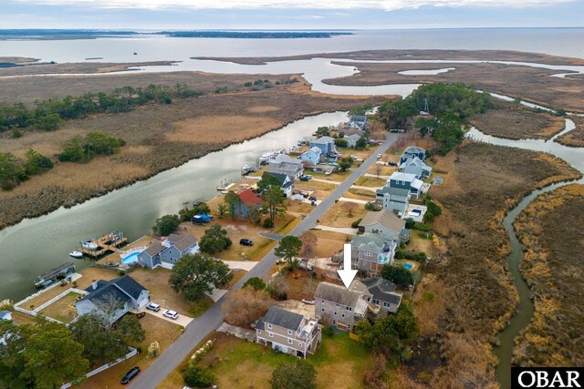 birds eye view of property with a water view and a residential view