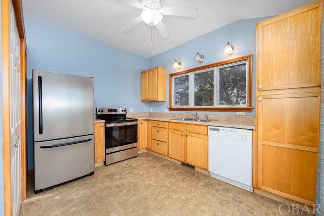 kitchen with stainless steel appliances, a sink, a ceiling fan, light countertops, and light brown cabinetry