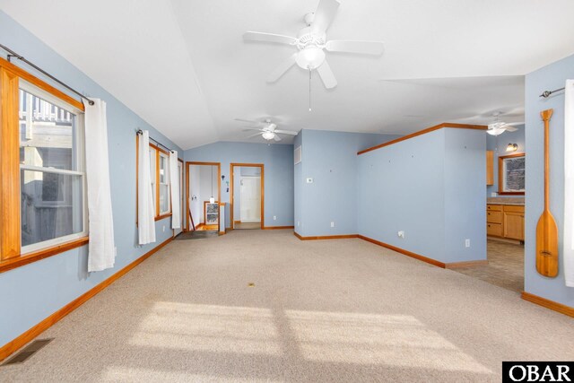 unfurnished room with baseboards, visible vents, a ceiling fan, lofted ceiling, and carpet