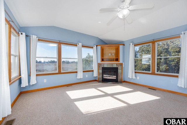 unfurnished living room with lofted ceiling, a fireplace with flush hearth, visible vents, and baseboards