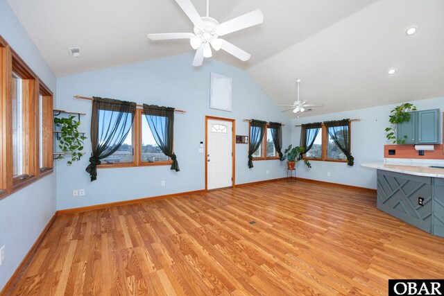 unfurnished living room with plenty of natural light, light wood-style flooring, and a ceiling fan