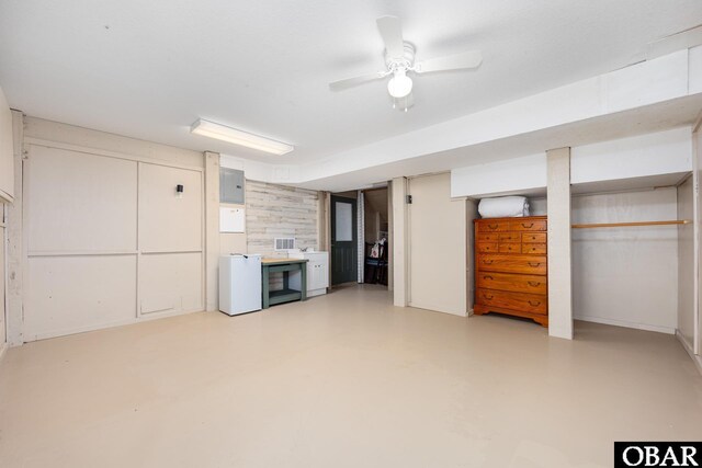 finished basement with a ceiling fan and visible vents