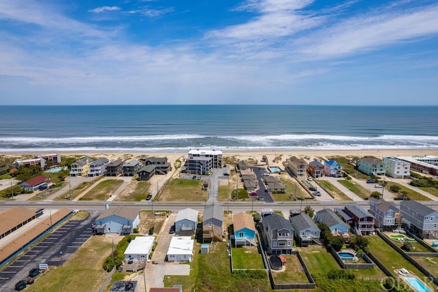 birds eye view of property with a view of the beach, a water view, and a residential view