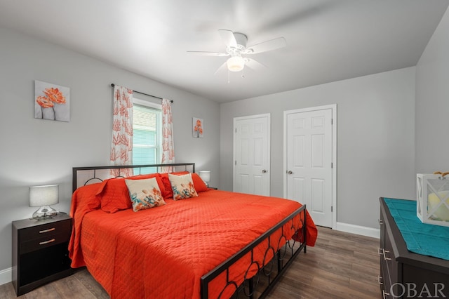 bedroom with dark wood-style floors, baseboards, and a ceiling fan